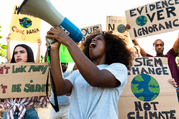istock Group of activists protesting for climate change during covid19 - Multiracial people fighting on road holding banners on environments disasters - Global warming concept 1351476545