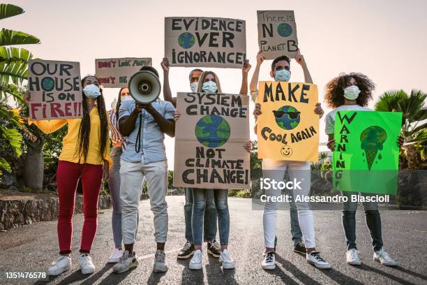 Group Of Activists Protesting For Climate Change During Covid19 Multiracial People Fighting On Road Holding Banners On Environments Disasters Global Warming Concept Stock Photo - Download Image Now