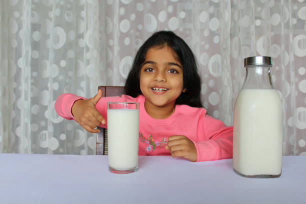 istock Little Girl Drinking Milk 1351477185