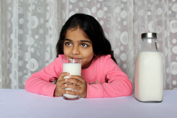 istock Little Girl Drinking Milk 1351477191