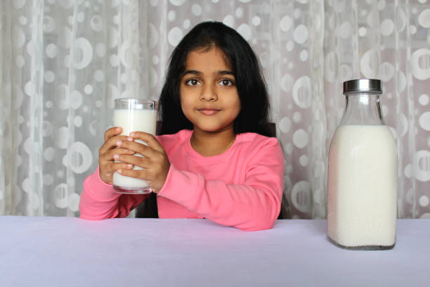 istock Little Girl Drinking Milk 1351477196