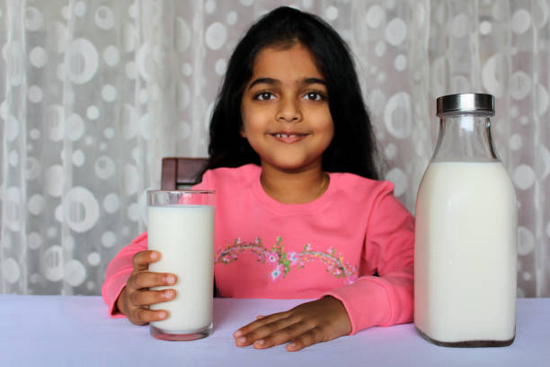 istock Little Girl Drinking Milk 1351477198