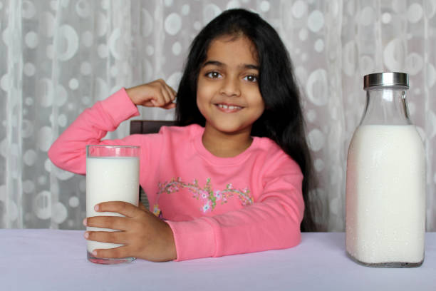 istock Little Girl Drinking Milk 1351477206