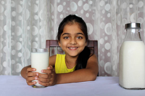 istock Little Girl Drinking Milk 1351477216