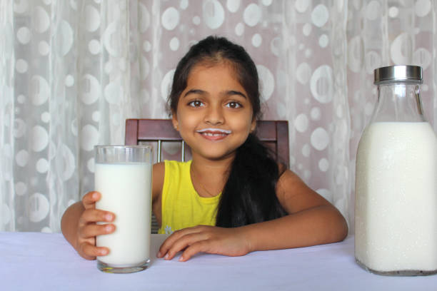 istock Little Girl Drinking Milk 1351477220