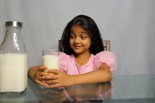 istock Little Girl Drinking Milk 1351477223