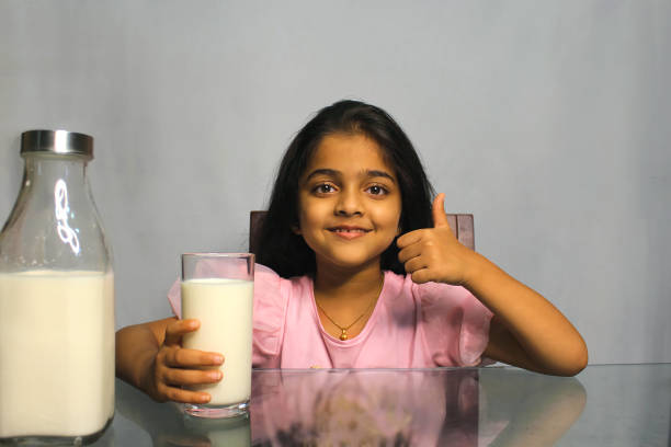 istock Little Girl Drinking Milk 1351477226