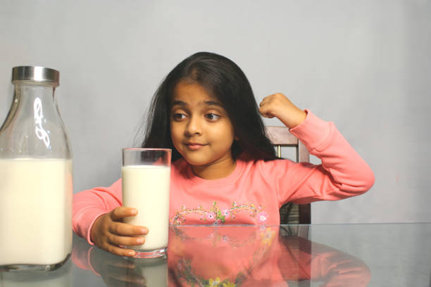 istock Little Girl Drinking Milk 1351477238