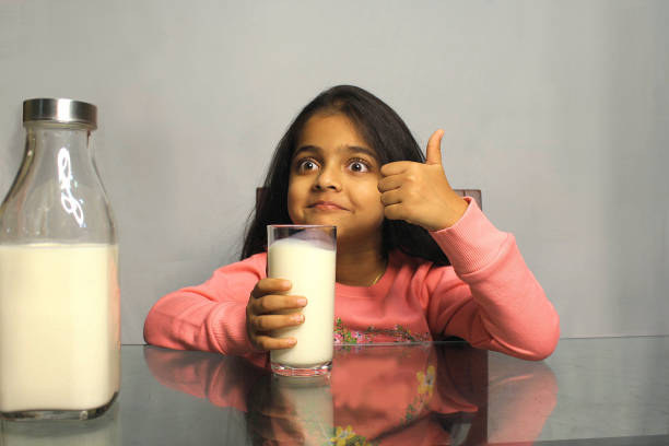 istock Little Girl Drinking Milk 1351477241