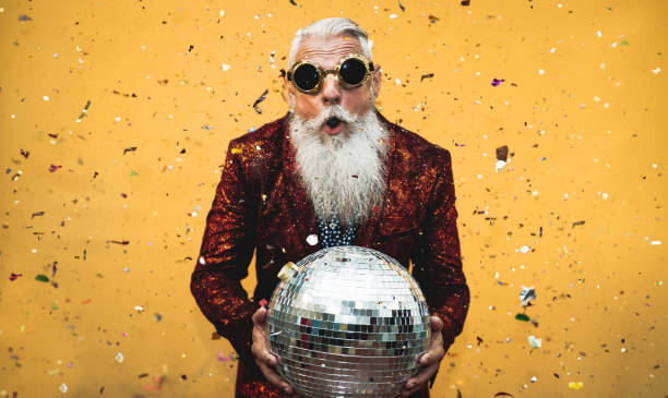 Crazy senior man having fun doing party during holidays time - Elderly people celebrating life concept stock photo