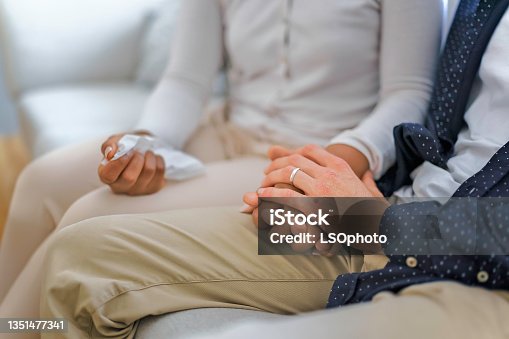istock hand holding tissu of a couple sit on sofa 1351477341