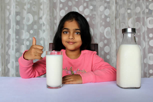 istock Little Girl Drinking Milk 1351477356