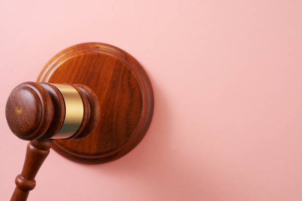istock wooden gavel hammer on pink background 1351478904