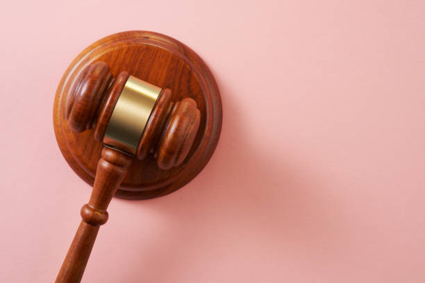 istock wooden gavel hammer on pink background 1351478905