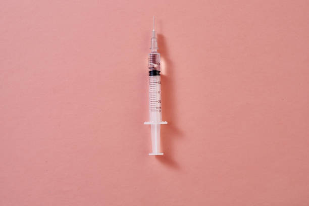 istock top view of  syringe on pink background 1351479037