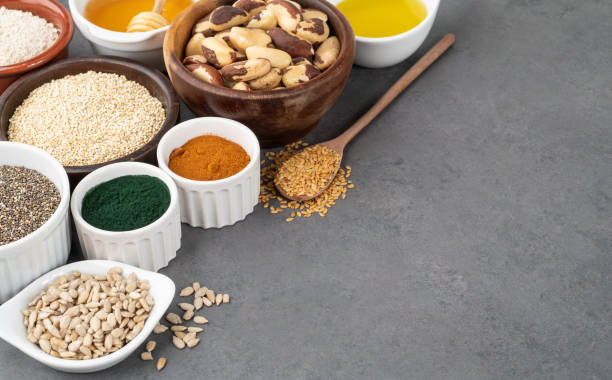 istock Assorted superfoods in spoons over stone background with copy space. Chia, quinoa, oat, linseed, honey, spirulina and others 1351480473