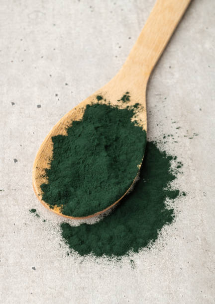 istock Spirulina algae powder in a spoon over wooden table 1351480479