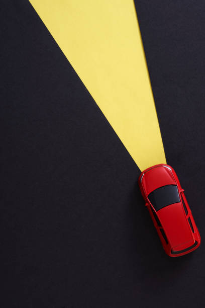 Red toy car with light ray