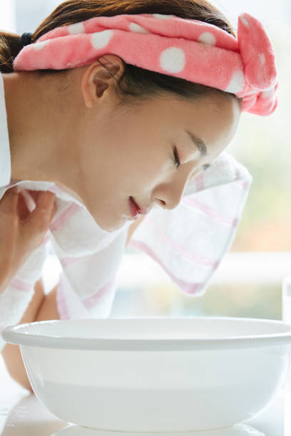 istock Young Asian woman washing her face 1351481976