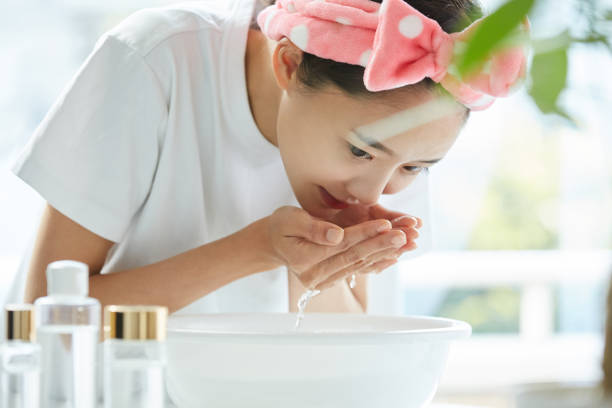 istock Young Asian woman washing her face 1351481989