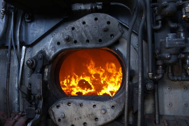 Steam Locomotive Fire firebox doors and coal fire in the cab of a steam locomotive firebox steam engine part stock pictures, royalty-free photos & images