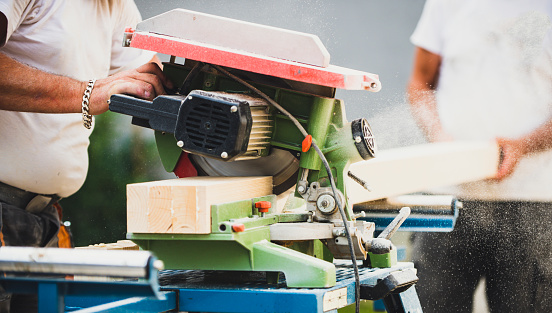 Carpenter using circular saw in DIY project. Circular saw in action. Close up