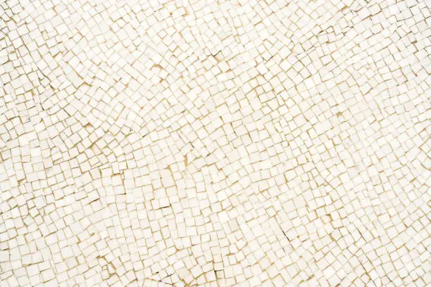 Photo of White mosaic tiled floor surface close-up