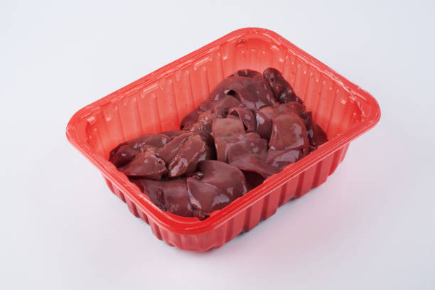 istock Raw chicken liver in red container close up isolated on white background with copy space 1351486511