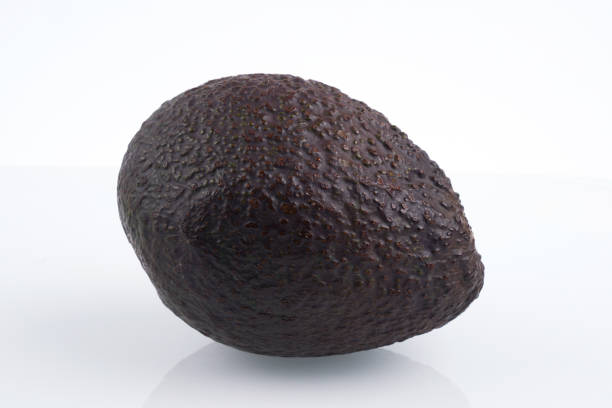 istock One whole haas avocado isolated on white background, flat lay clipping path 1351486615