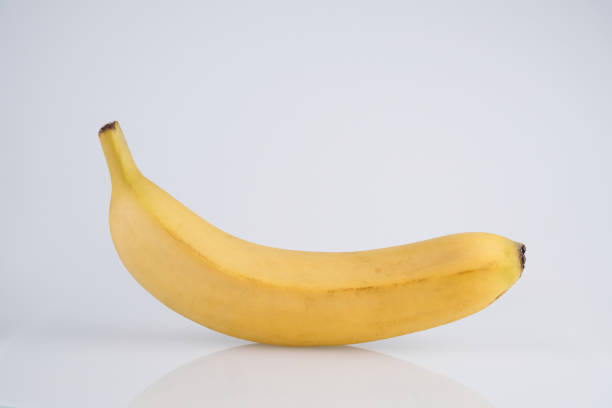 istock Whole yellow banana with peel isolated on white background with copy space, clipping path 1351486656