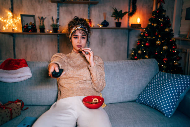 istock Woman watching tv at home 1351487427