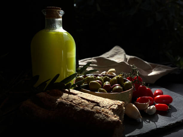 istock olive oil extra virgin bottle with olives,  first cold pressing oil, 1351489907