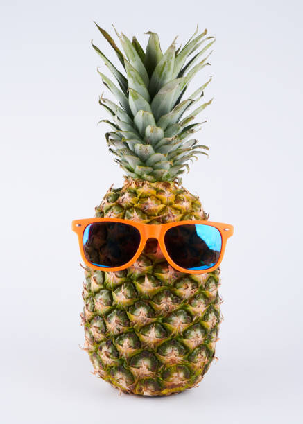 istock Pineapple in sunglasses isolated on white background, clipping path. Summer vacation concept and travel to warm countries, tropical fruit art 1351489945
