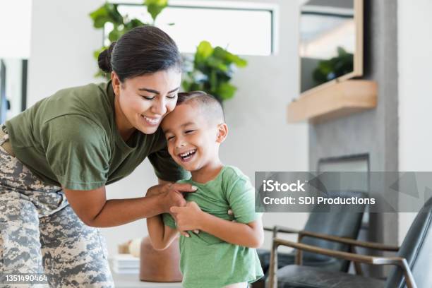 Solder Embraces Young Son Stock Photo - Download Image Now - Veteran, Embracing, Family