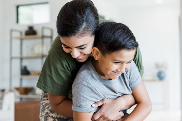 istock Female soldier hugs young son 1351490637