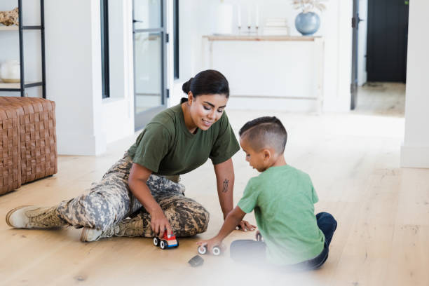 istock Soldier playing with son at home 1351490638