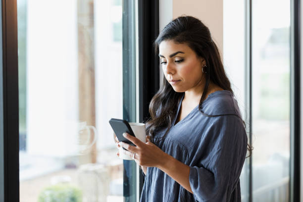 istock Woman reads text or social media while at home 1351490719