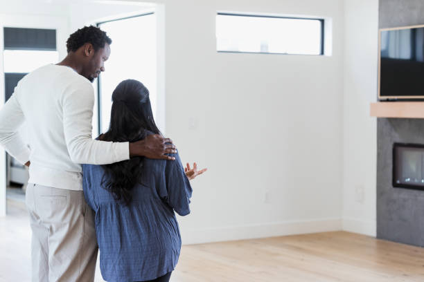 istock Happy couple plan decor in their new home 1351490722