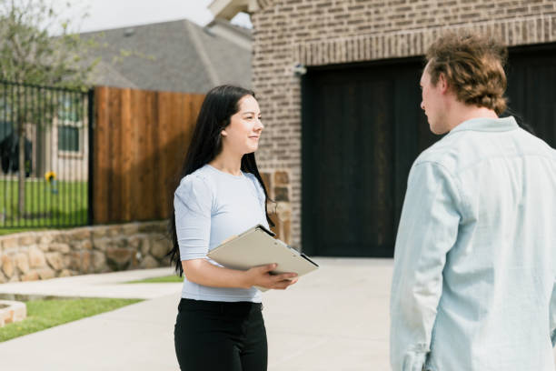 istock Female real estate agent listens to question from client 1351490831