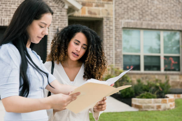 istock Real estate agent and female client discuss house contract 1351490842