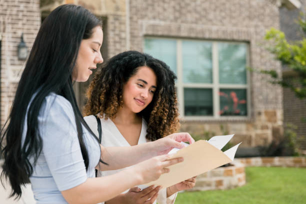istock Female client listens as real estate agent describes home 1351490845