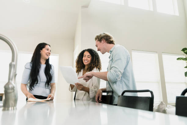 istock House agent and couple smile while discussing rental contract 1351490898
