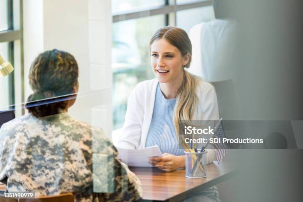 Excited Young Woman Meets With Female Army Recruiter Stock Photo - Download Image Now
