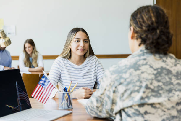 istock Young woman talking with military recruiter 1351490994