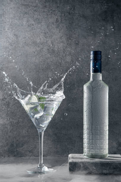 vodka splash su sfondo scuro con copyspace. - martini brand vermouth foto e immagini stock