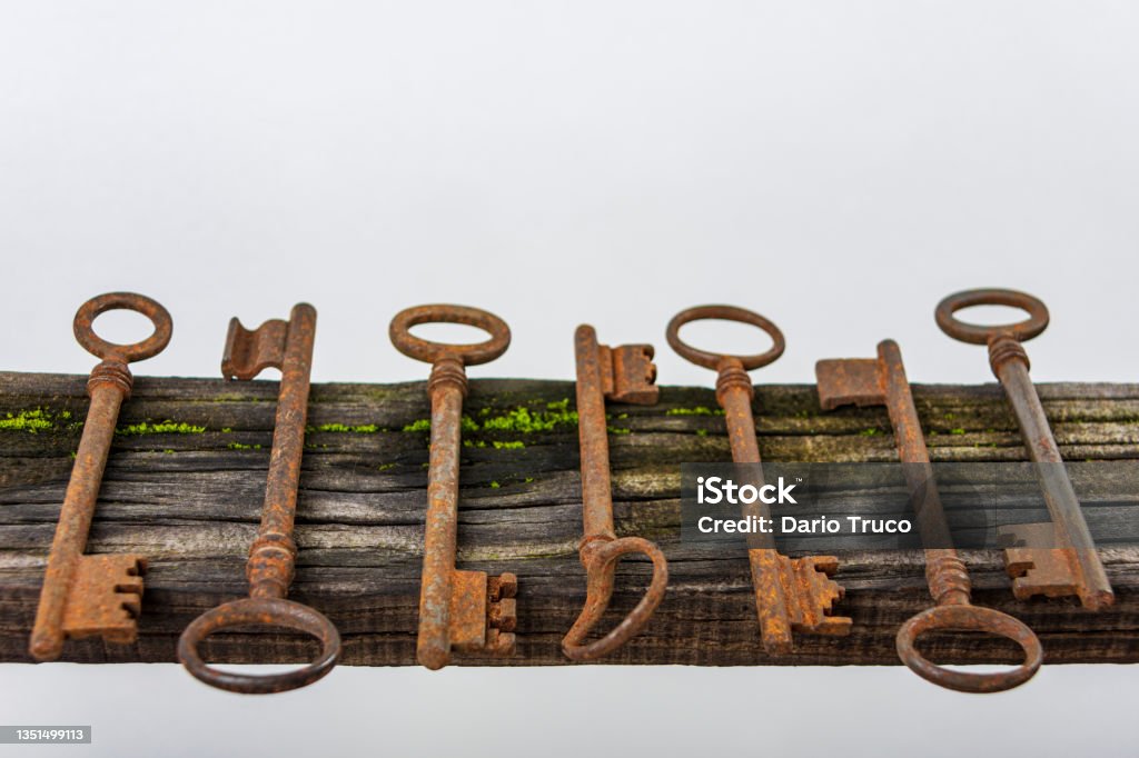 seven antique keys seven old key above rustic wood Ancient Stock Photo