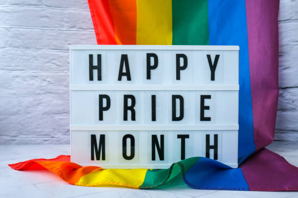 istock Rainbow flag with lightbox and text HAPPY PRIDE MONTH. Rainbow lgbtq flag made from silk material. Symbol of LGBTQ pride month. Equal rights. Peace and freedom 1351501447