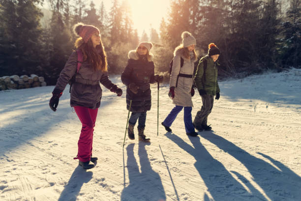 multi generation family enjoying hiking in winter forest. - group of people teenager snow winter imagens e fotografias de stock