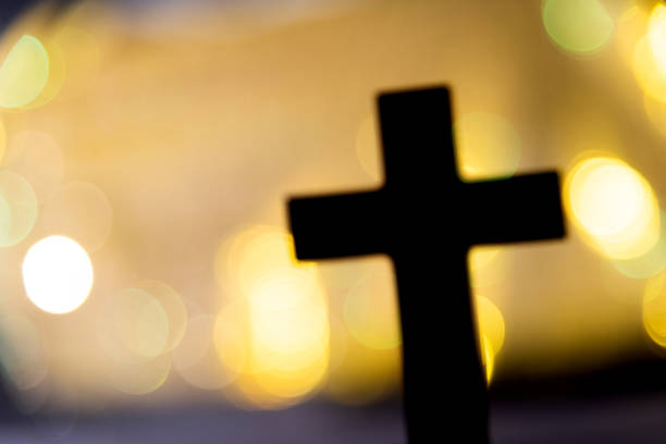 istock Backgrounds of religious cross and defocused lights 1351502554