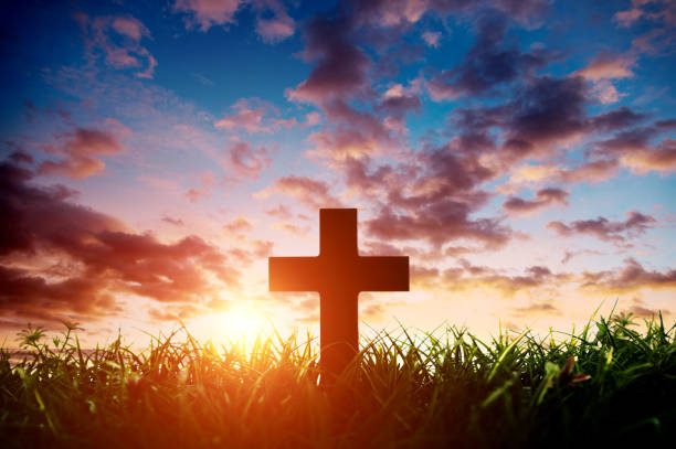 istock Religious cross on the hill at sunset 1351502616